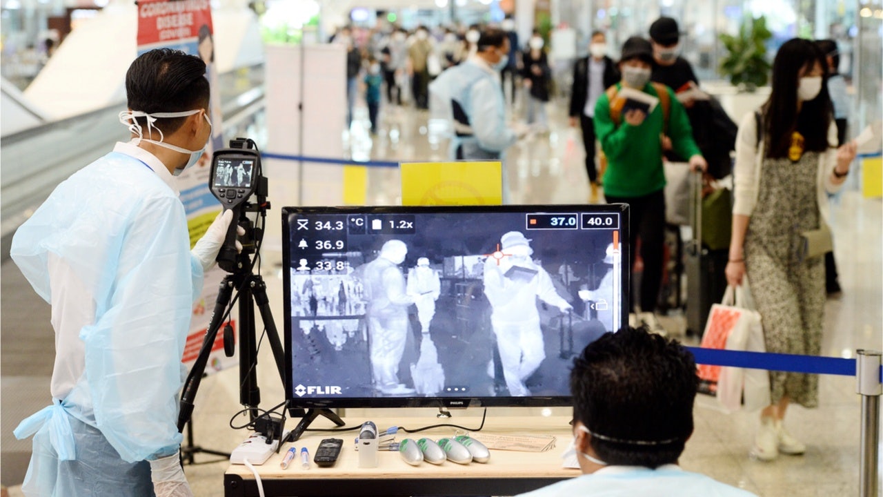 Chinese travelers are overwhelmed with anxiety and fear, which has been instilled by SARS in 2004, and as the first victims of the global pandemic. Photo: Shutterstock/a thermal scanner at Kuala Lumpur International Airport