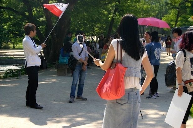 A Chinese tourist takes a selfie at Gyeongbokgung Palace in Seoul, South Korea. (Jing Daily)