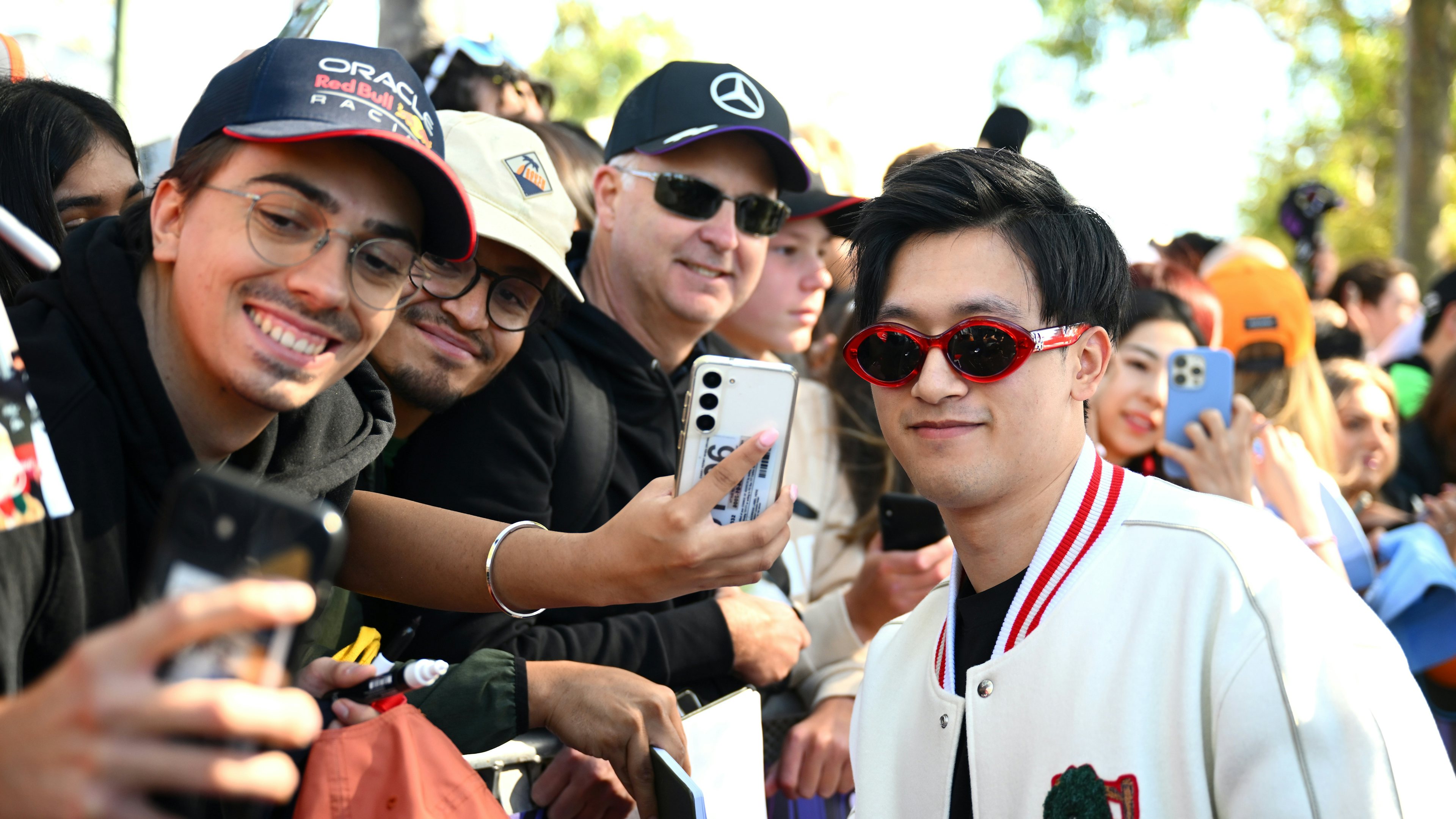 Zhou Guanyu, right, greets fans ahead of the F1 Grand Prix of Australia at Albert Park Circuit on March 21, 2024 in Melbourne, Australia. Photo: Getty Images