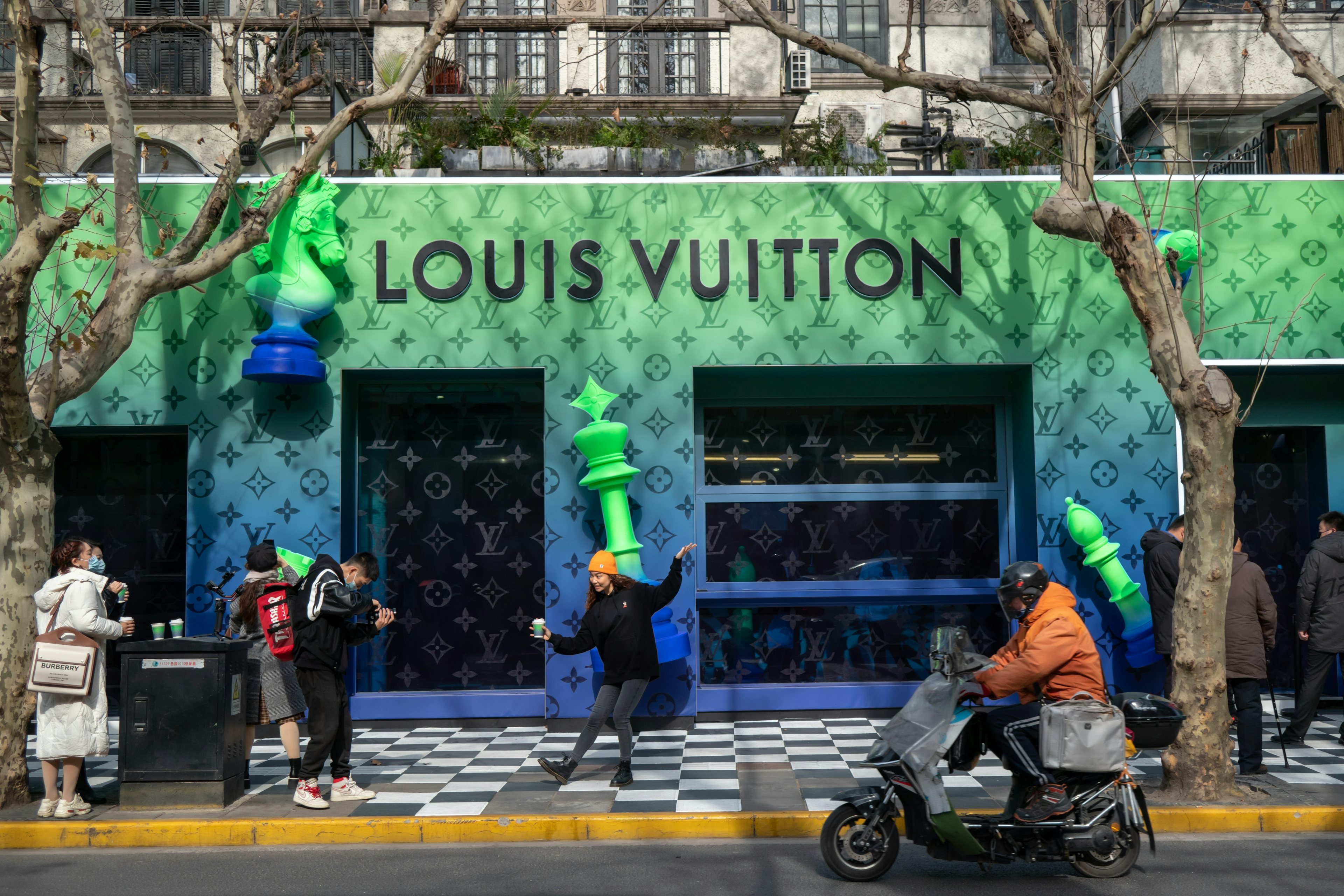 People outside a Louis Vuitton store in China.  