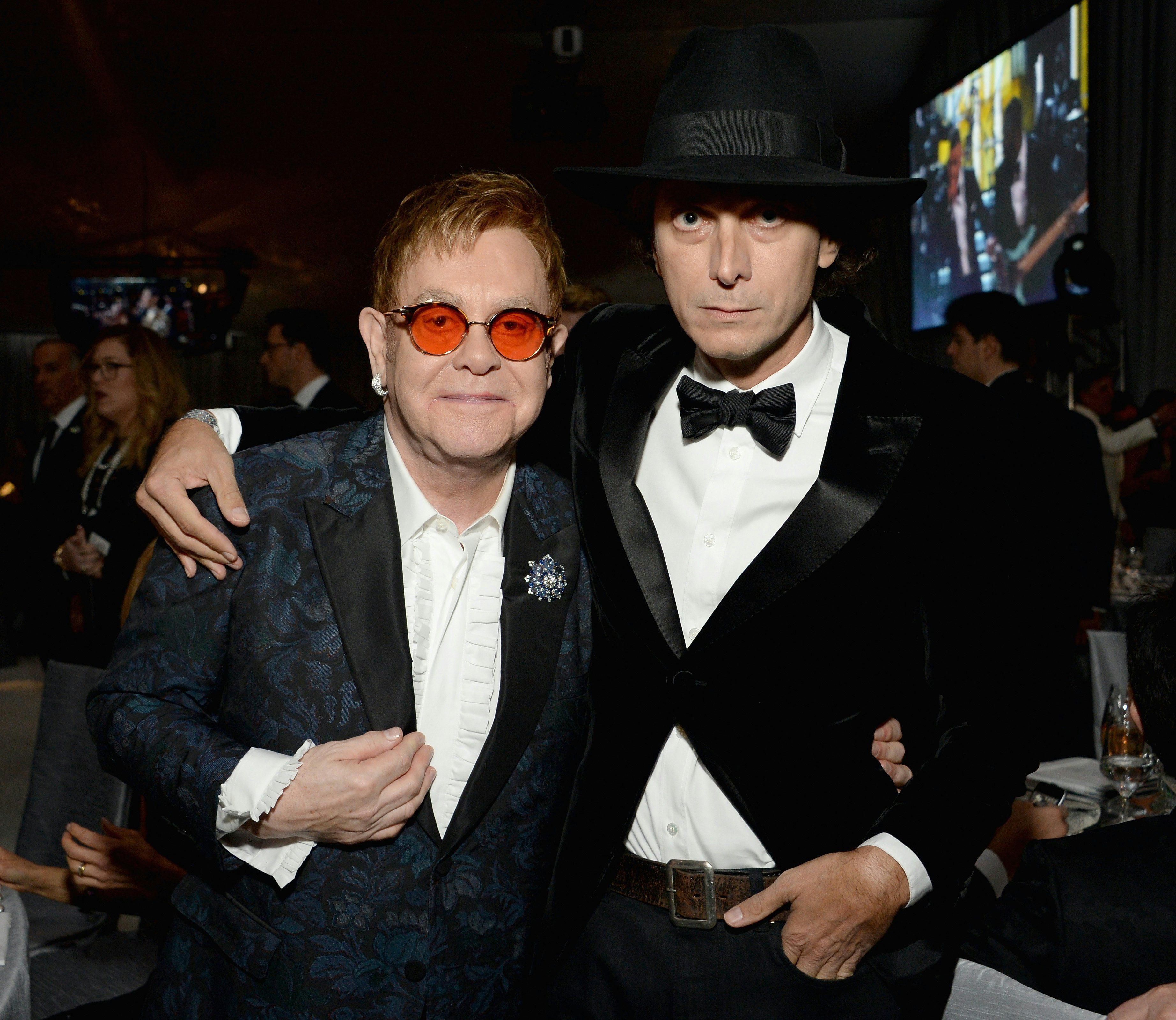 Sir Elton John, left, and designer Hedi Slimane attend a party at The City of West Hollywood Park. Photo: Ghetty Images