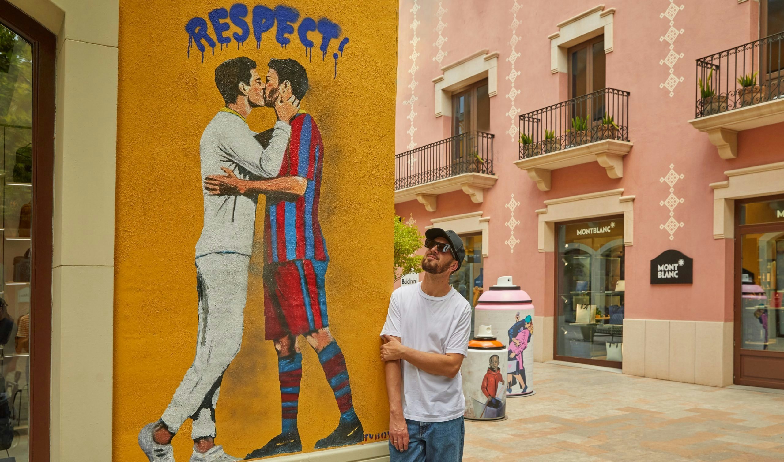 TVBoy stands with one of his most famous illustrations of Ronaldo and Messi, currently seen at La Roca Village. Photo: La Roca Village