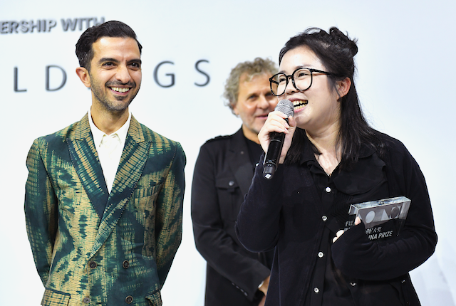 Caroline Hu receiving prize from BoF Editor-in-Chief, Imran Amed. Photo: Getty Images for The Business of Fashion