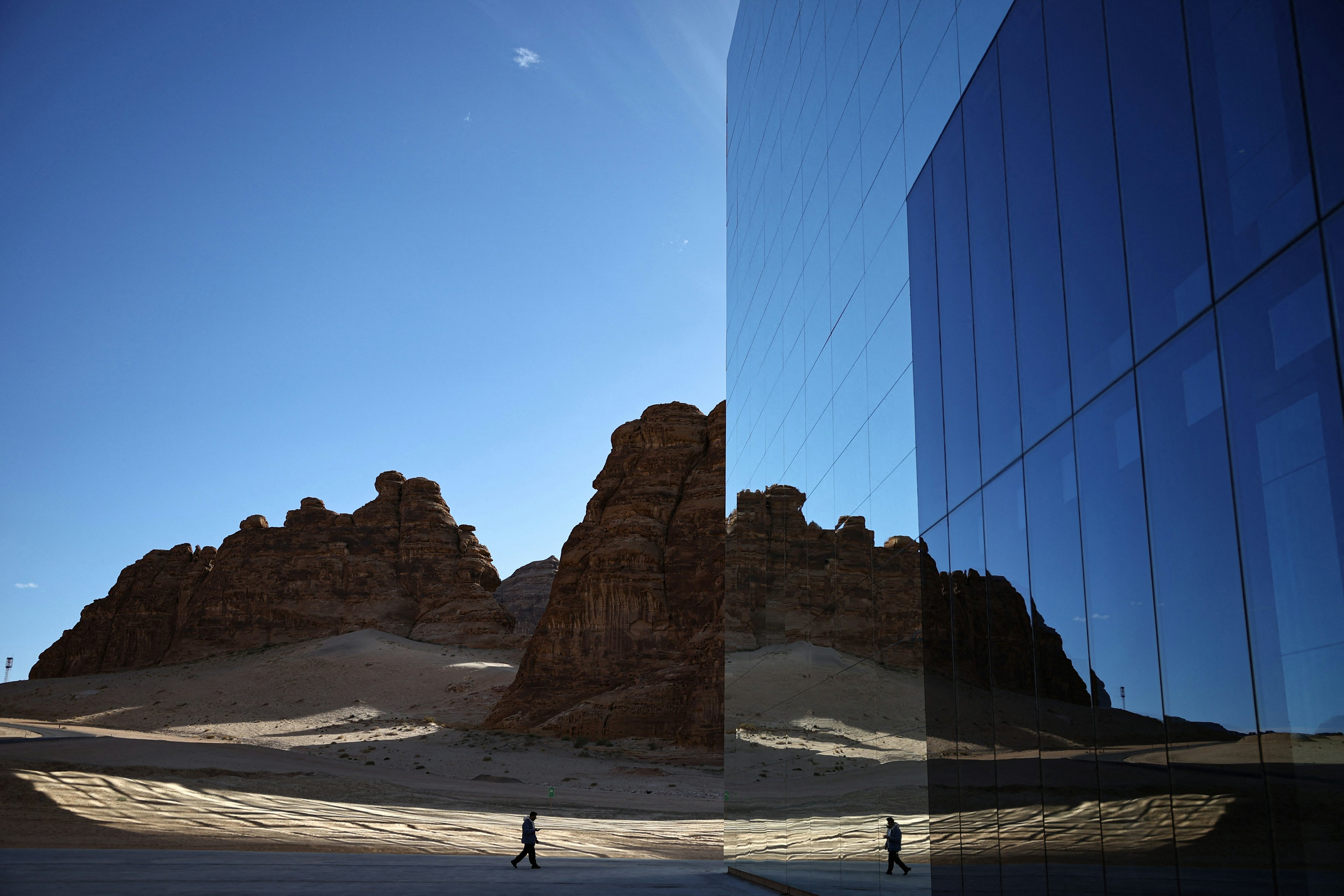 A man walks in front of the Maraya (Mirror), the world’s largest mirrored building,  in Saudi Arabia’s northwestern Al-Ula desert. Photo: Getty Images