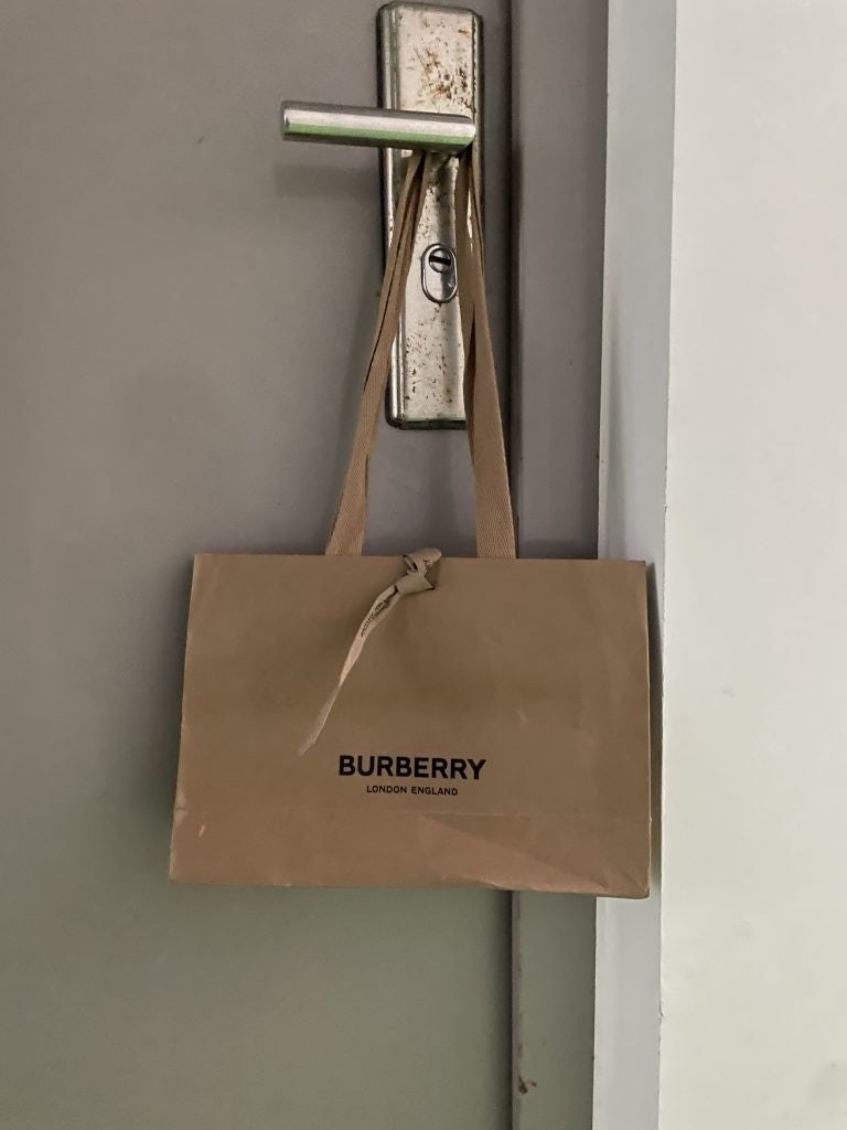 Shanghai residents hang luxury paper bags on their door to hold their at-home antigen tests. Photo: Jing Daily