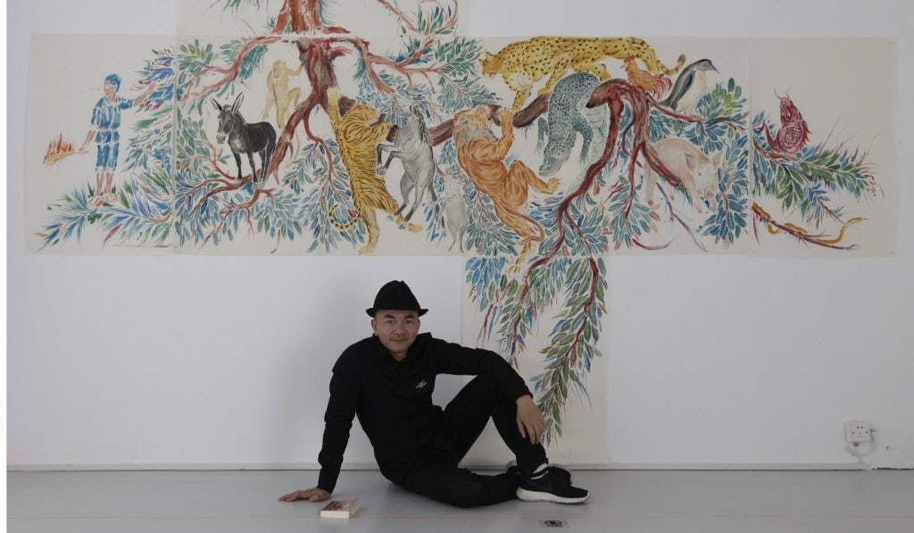 Chinese contemporary artist Wu Junyong with his multimedia illustration, "Flying Ark" at K11's Vivienne Westwood exhibition in Shanghai. (Courtesy Photo)