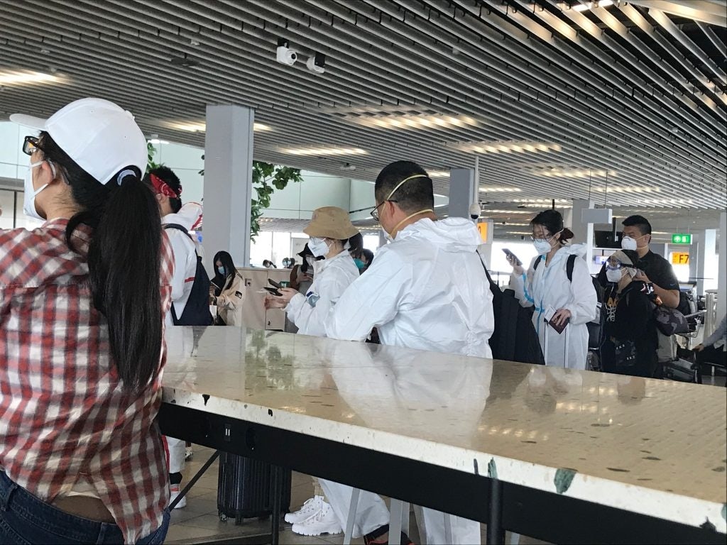 Out of a few hundred, almost one-fourth of my fellow Chinese passengers are in full protective gear at the boarding area. Photo: Yaling Jiang