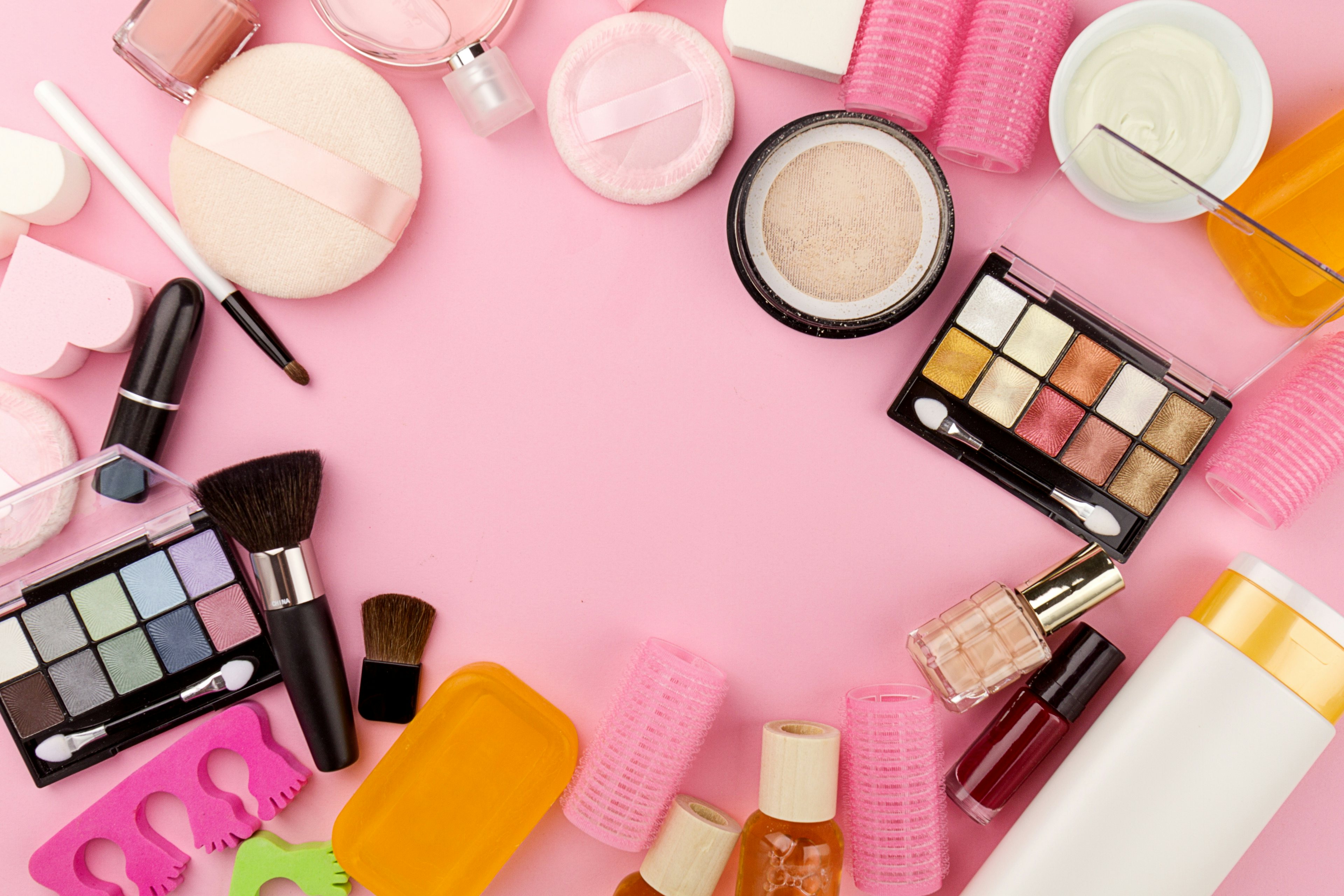 Beauty Spa Feminine Concept. Different Makeup Beauty Care Essentials Cosmetics on Flat Lay Pink Background. Top View. Above. Photo: freepik