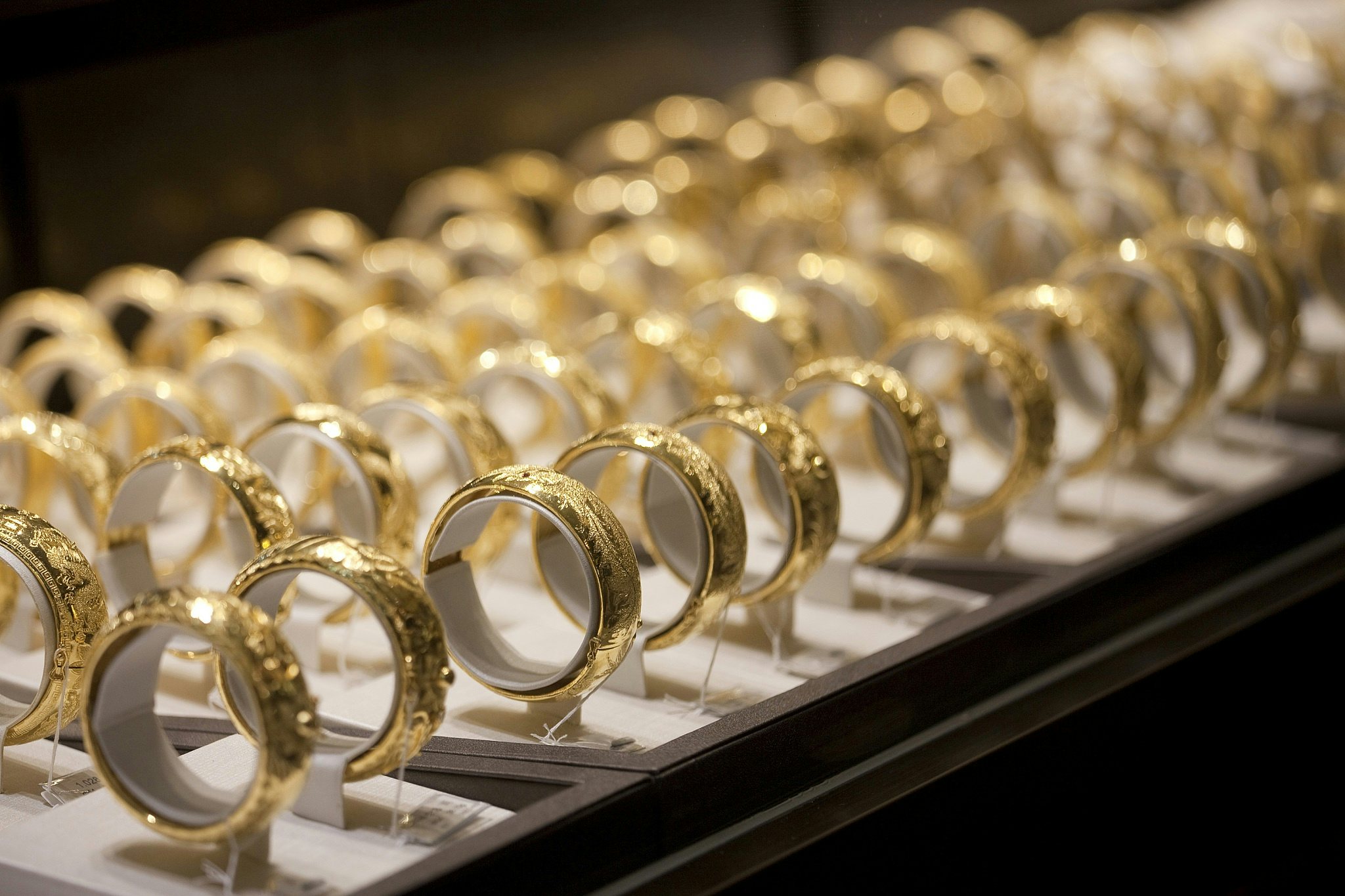 Gold bracelets for sale are displayed in a Chow Tai Fook Group jewelry store in Hong Kong, China. Photographer: Jerome Favre/Bloomberg