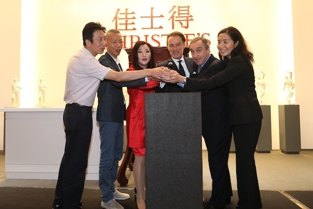 Christie's executives and organizers tap the gavel for the sale of Cai Guo-Qiang's charity piece. (Christie's)  