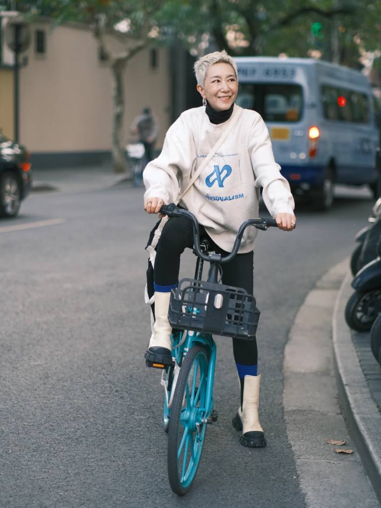 “Sister Ma,” a 60-year-old fashionista, bikes in Shanghai. China’s seniors are affluent and highly educated. Image: Xiaohongshu