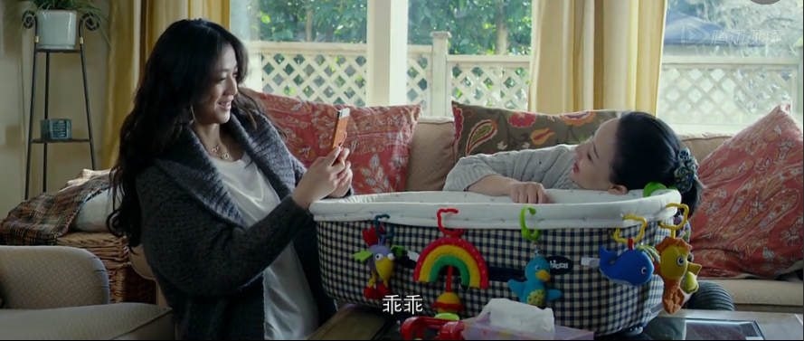 A screen capture from the "Beijing Meets Seattle" film featuring the new baby in a care center.