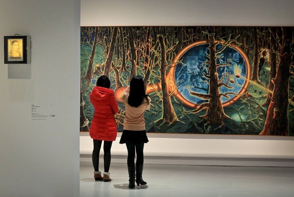 Visitors gather to admire works from "Electric Fields: Surrealism and Beyond -- La Collection du Centre Pompidou," in Shanghai. The Pompidou show will be on display for three months. (AFP/Getty Images / December 17, 2012)