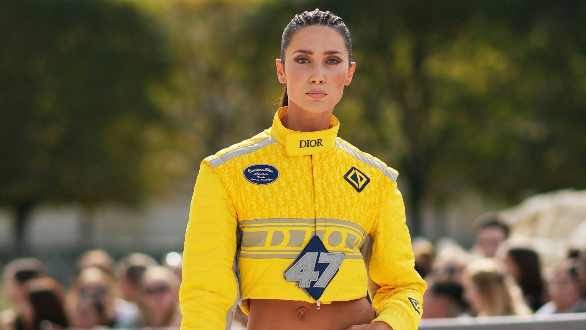 Model Sabina Jakubowicz wears a yellow Dior jacket designed as a F1 driver jacket to attend Dior's Spring 2024 show. Photo: Getty Images