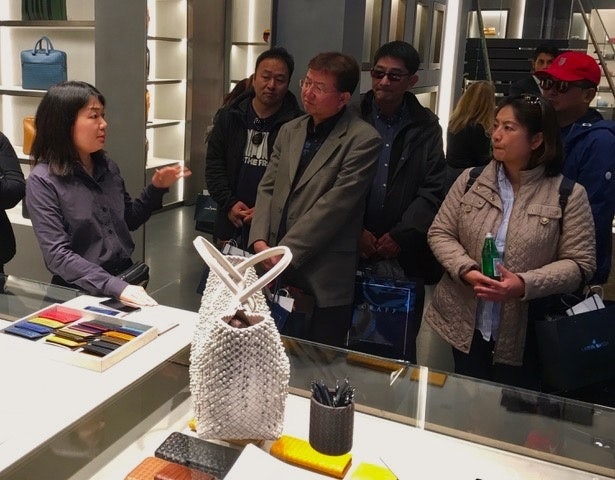 Chinese tour guides learning about products at Bottega Veneta. Courtesy Photo
