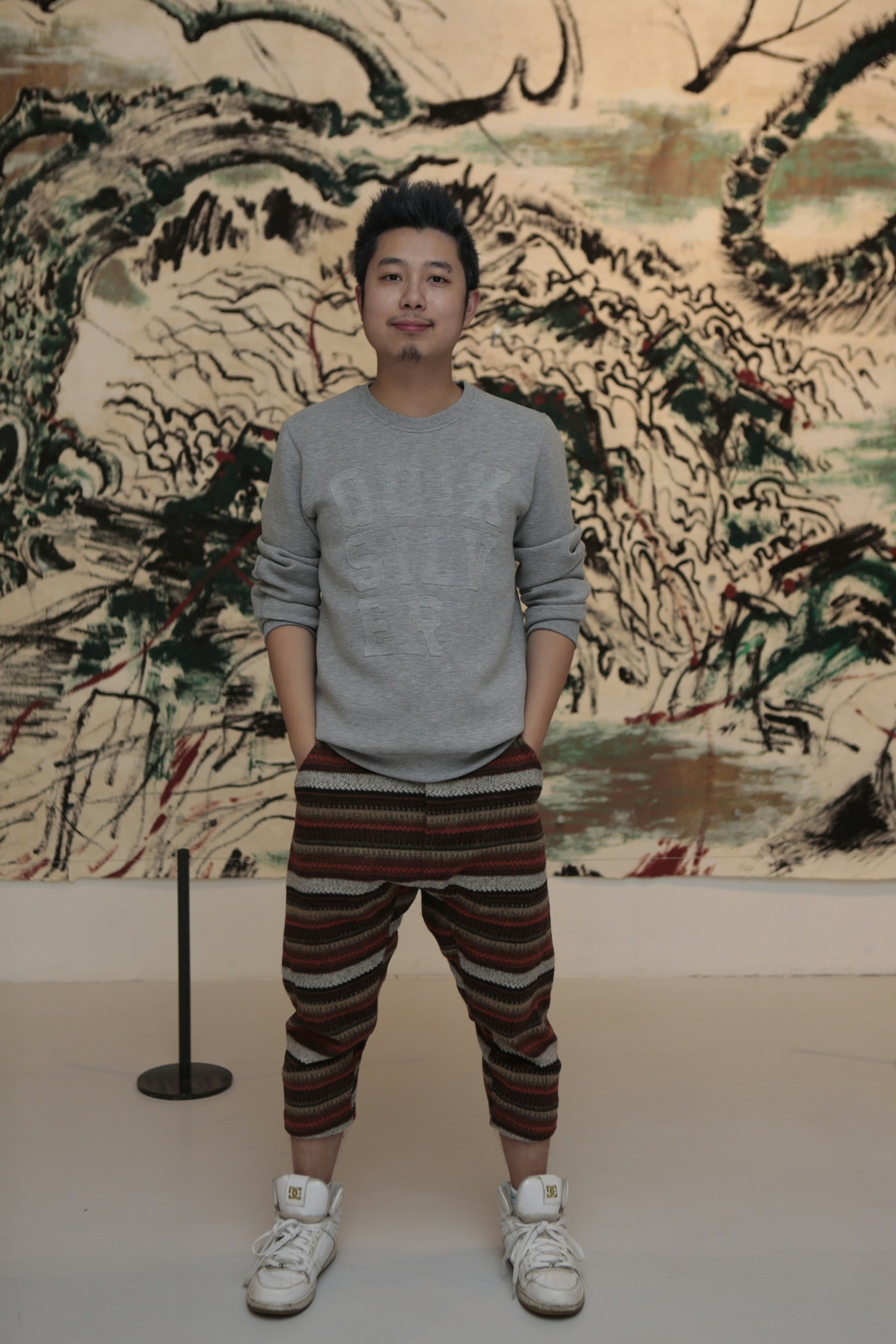 Curator Song Zhenxi stands in front of Sun Xun's mural, the Chinese contemporary art response to Vivienne Westwood's exhibition. (Courtesy Photo)