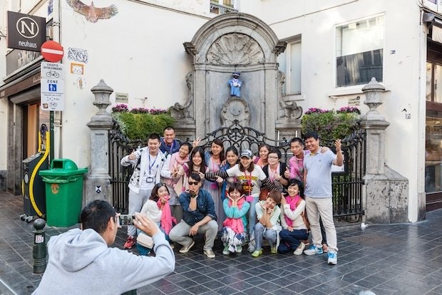 A Chinese travel group takes a photo in Belgium. (Shutterstock)
