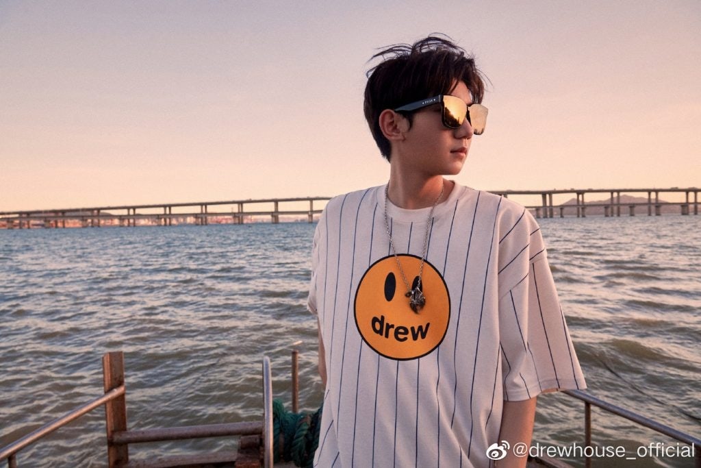 Chinese singer Wang Yuan sports the Drew House logo, which is a smiley face with the word “drew” in place of the mouth. Photo: Drew House's Weibo