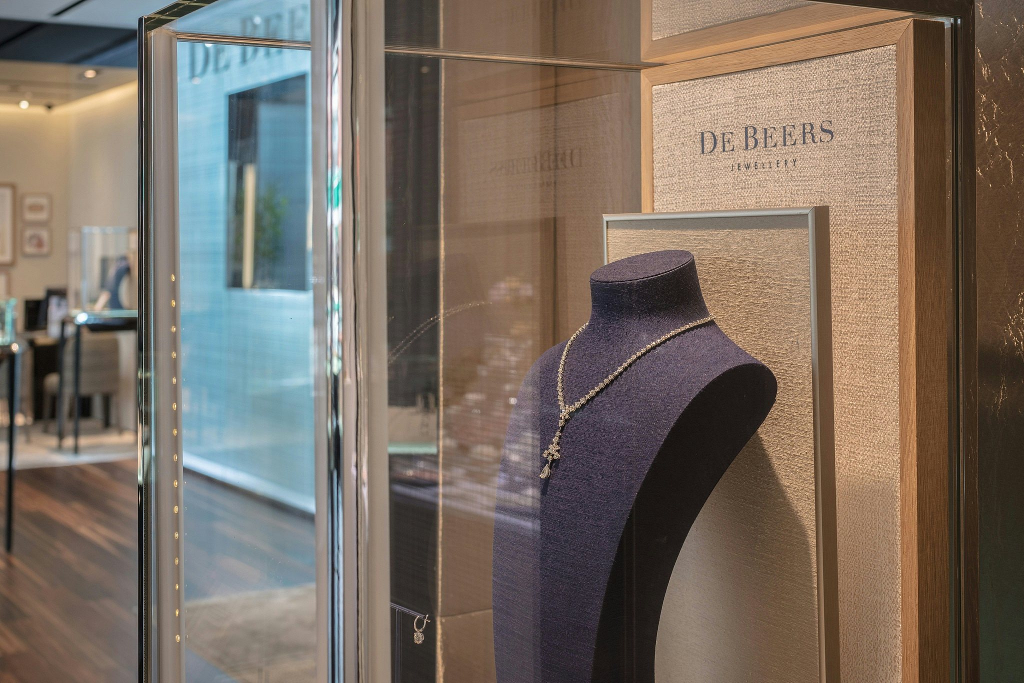A diamond necklace is displayed in a cabinet inside a De Beers SA store in Hong Kong, China. Photo: VCG