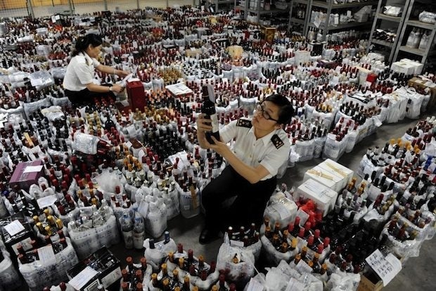Guangzhou customs officials inspect wine bottles. Smuggling wine from Hong Kong to the mainland is a lucrative operation for those who don't get caught.