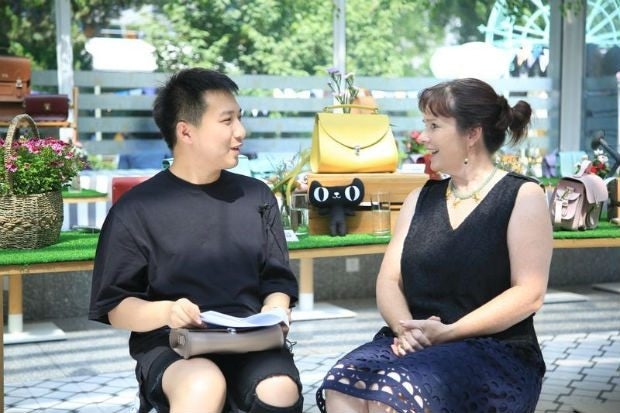 Fashion blogger Tao Liang, a.k.a. Mr. Bags, meets with Cambridge Satchel Company founder and CEO Julie Deane at the Tmall launch event. (Courtesy Photo)