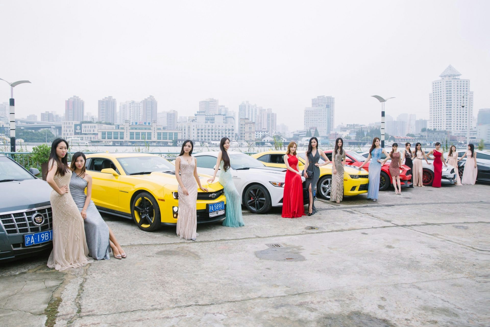 Members of the fan club for, Ayawawa, a well-known author on relationships in China, gather around luxury cars for a Ms Paris event. (Courtesy Photo) 