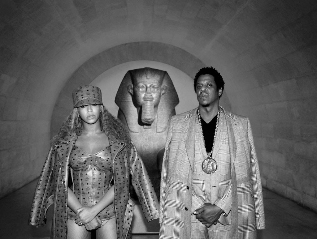 Beyoncé wears an MCM logo–covered bustier and overcoat designed by Misa Hylton in her "Apeshit" music video.