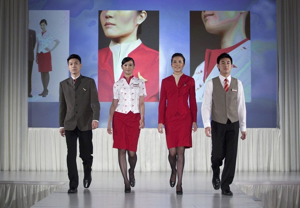 Cathay Pacific Airways Ltd. flight attendants walk down the catwalk to present the company's new uniforms in Hong Kong, China, on Wednesday, June 22, 2011. Photographer: Jerome Favre/Bloomberg