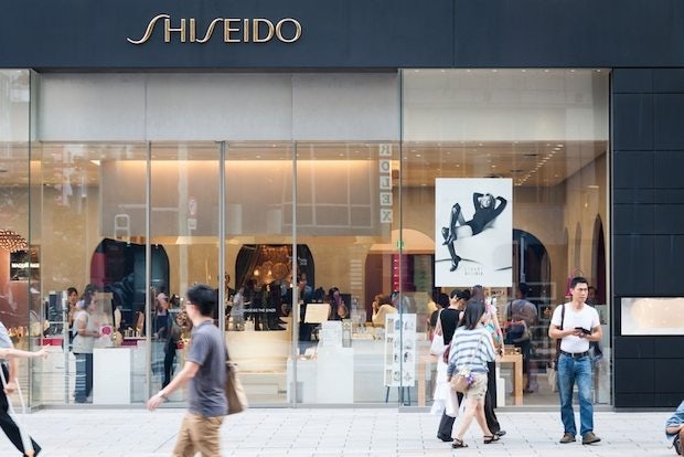 Shoppers and tourists pass by a Shiseido shop in Tokyo's Ginza district. (Shutterstock)