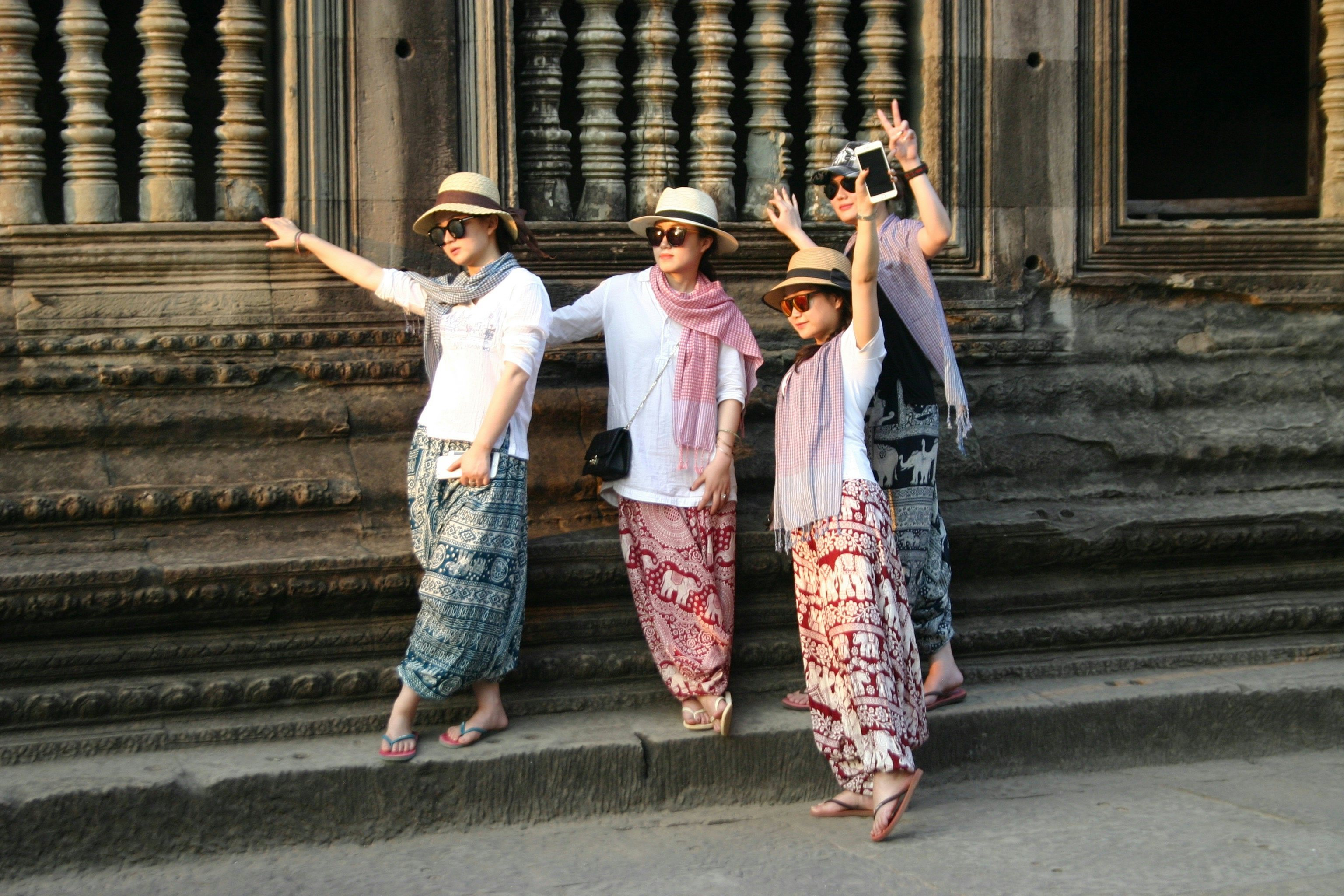 Chinese tourists pose for a picture at Angkor Wat in Cambodia. (Jing Daily)