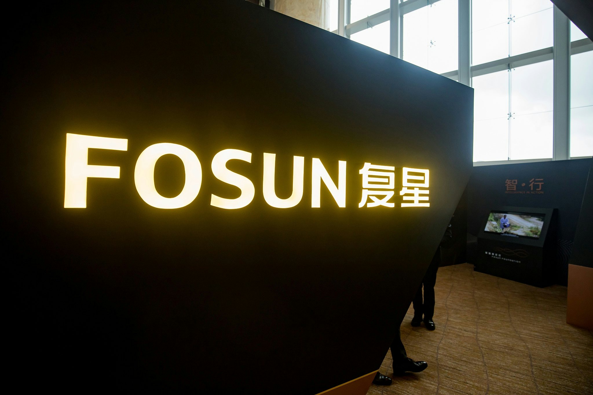 Fosun International Ltd. branding is displayed in an exhibition area during a news conference in Hong Kong, China. Photographer: Paul Yeung/Bloomberg