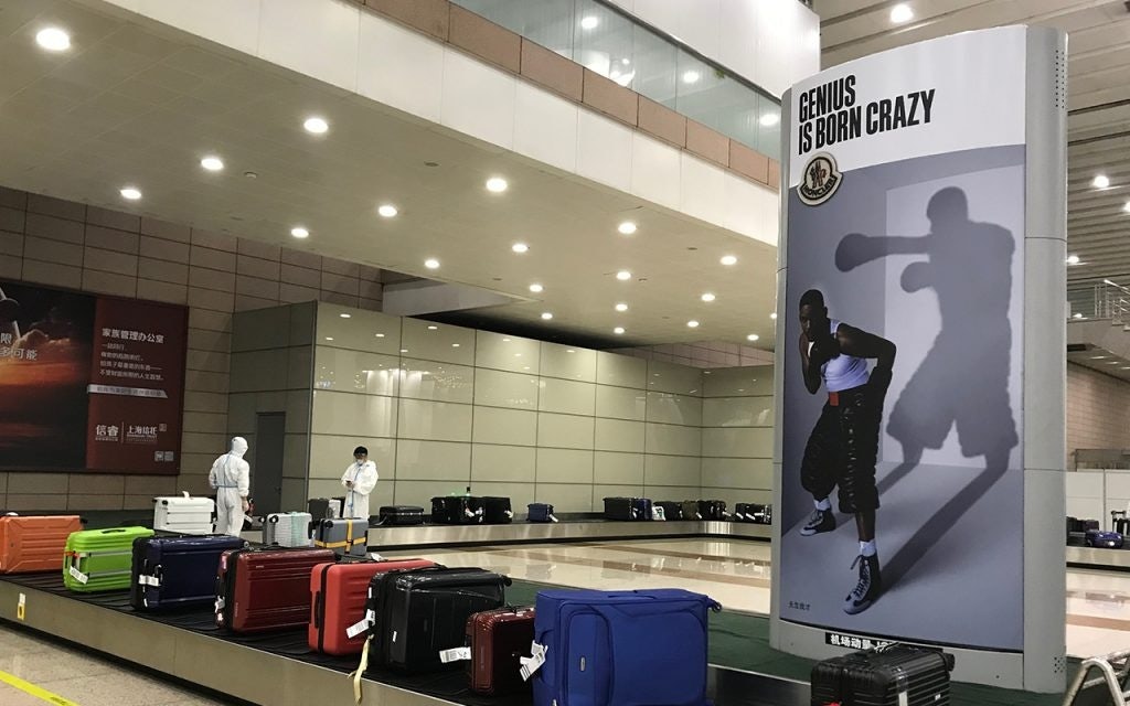 Passengers on my flight are welcomed by Moncler Genius ads at the luggage belt. After this point, we will be dispatched to different quarantine hotels. Photo: Yaling Jiang